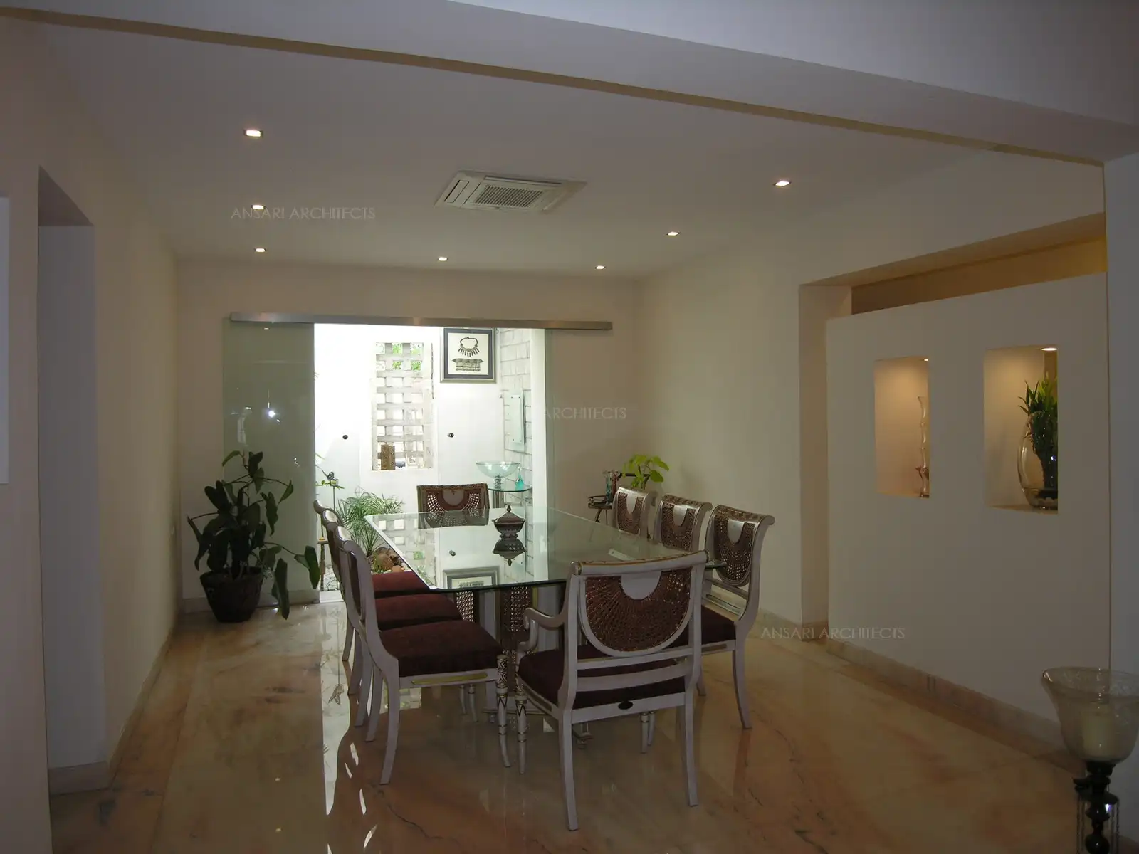 Dining room, which which looks to the courtyard through a clear sliding glass.