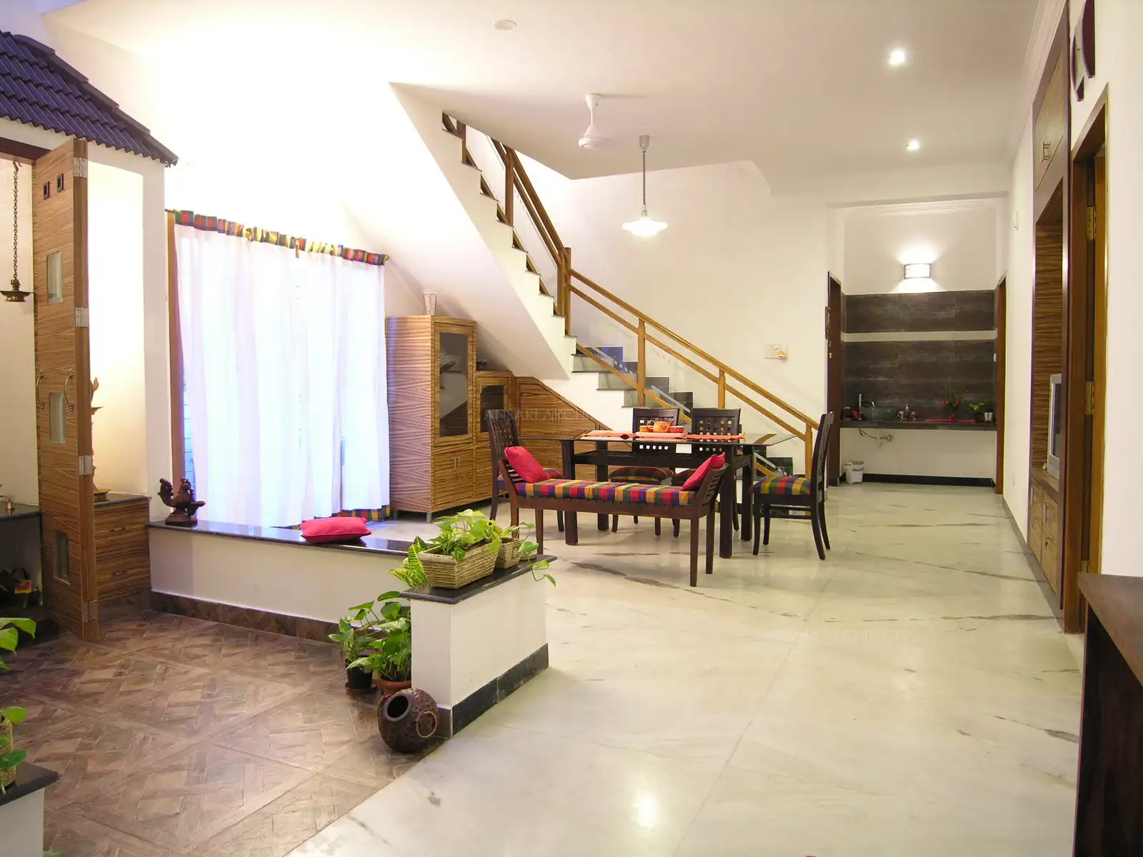Dining area near the staircase is bright and spacious with large French window