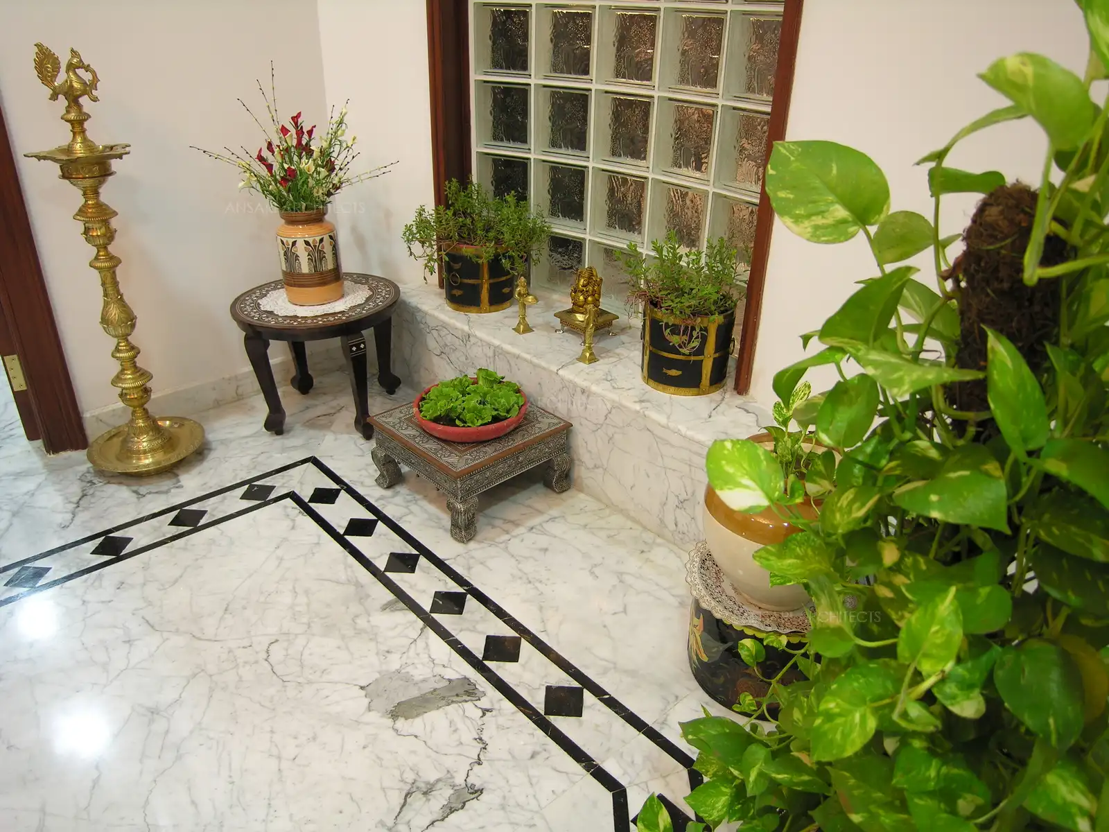 The front fire is adopted with beautiful indoor plants in variety of traditional looking pots. And the very traditional “Kuthu Vilakku” which has been a part of Tamil houses for centuries, also greets you.
