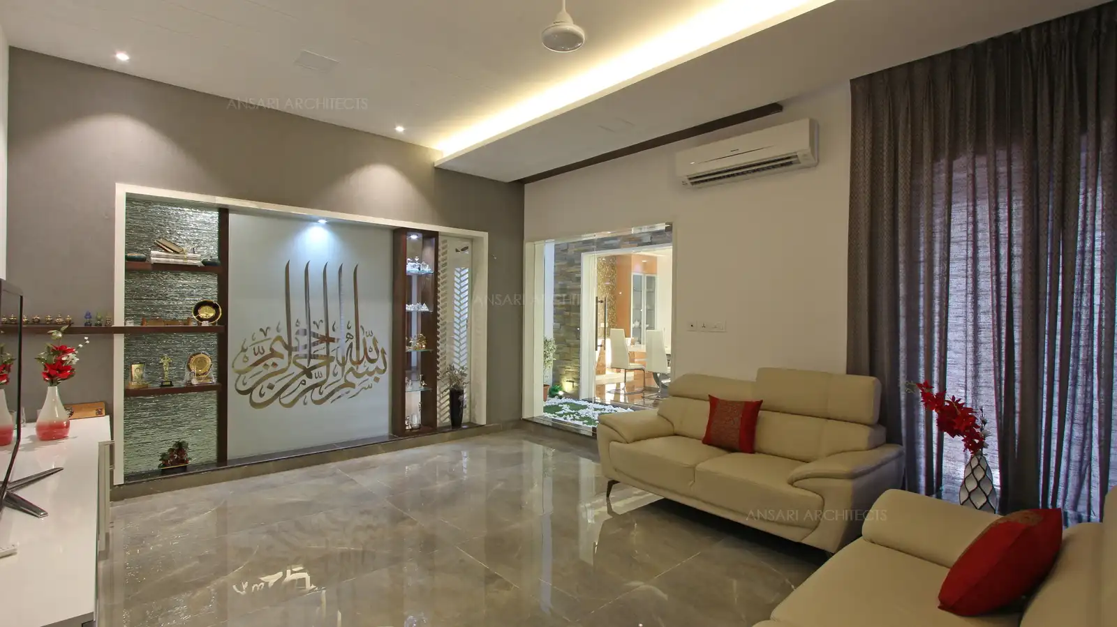 The featured acccent wall with islamic inscriptions looks majestic and offers a serene effect, it provides a visual break here, artifacts provide an interesting feature with lights providing a soft glow.