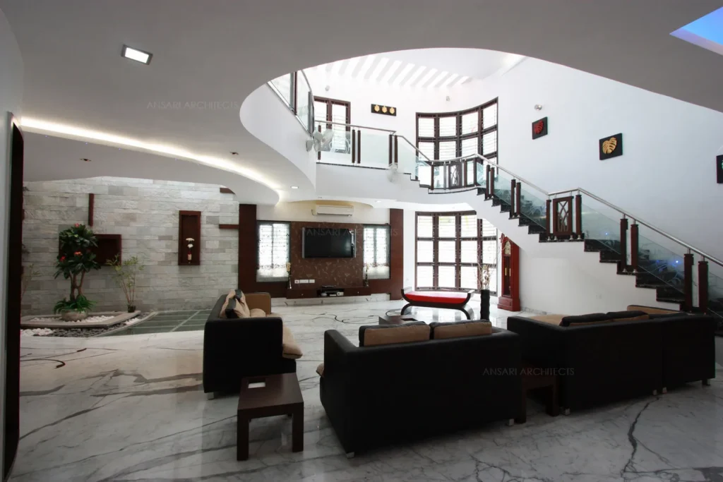 a room with a staircase and couches