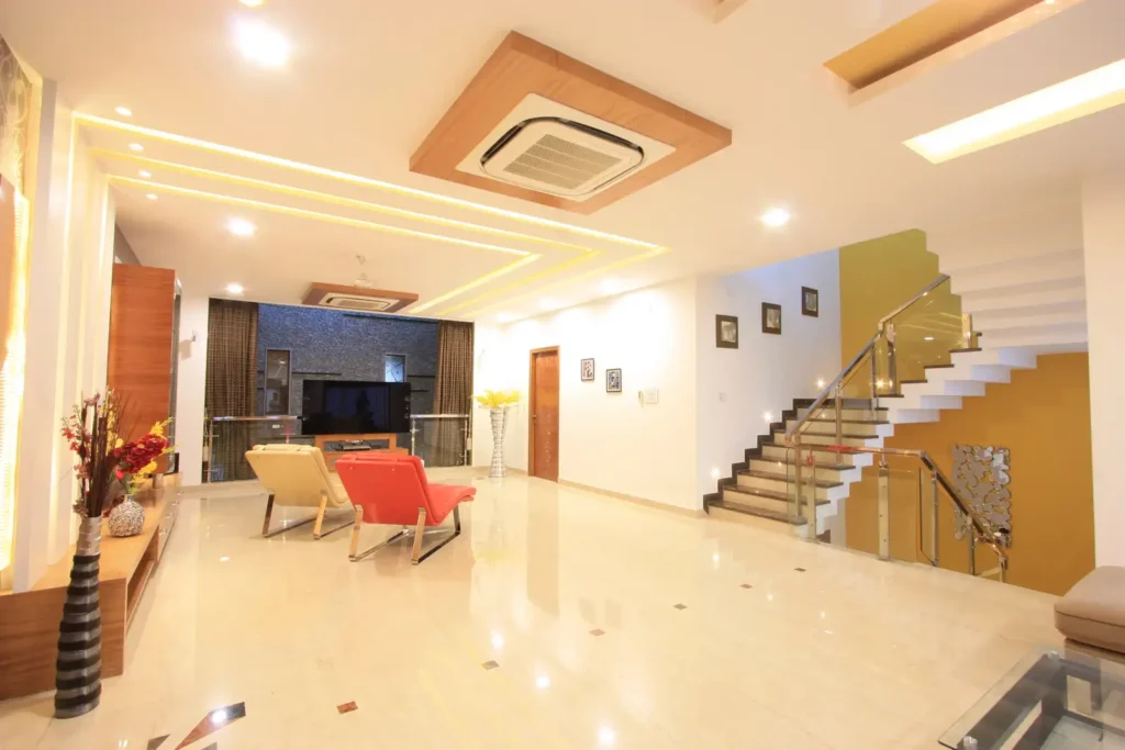 a room with a staircase and chairs