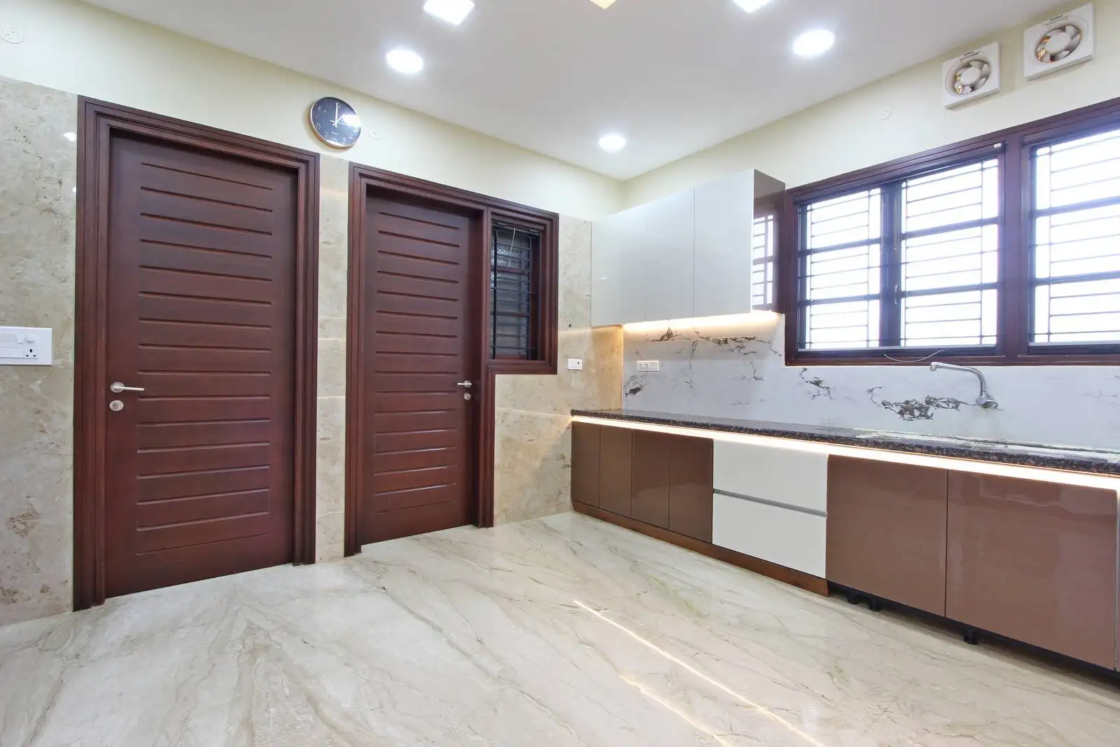 Two-tone, handle-less cabinetry offers a sleek, modern aesthetic with clean lines and visual harmony.