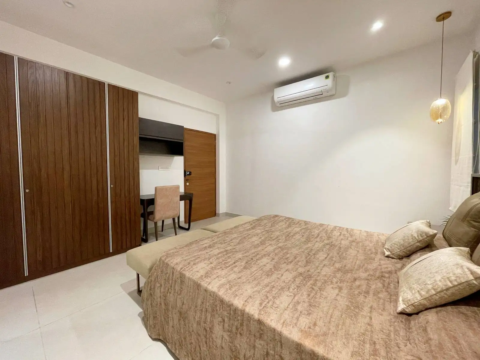 This bedroom showcases modern minimalist design with warm wood finishes, integrated storage, and a compact study nook for a serene, functional retreat. Clean lines, neutral tones, and subtle lighting enhance comfort, flow, and visual harmony.