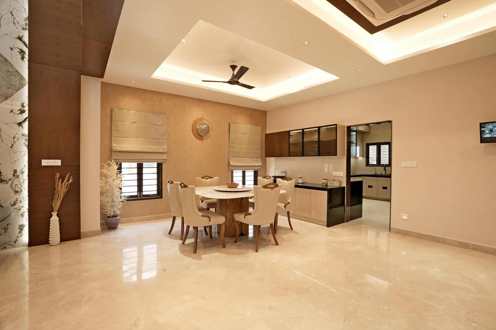 Dining Area ( 24'0" x 17'0" sq.ft ) is a central, open-plan space connecting the kitchen and living zones. Polished marble flooring, warm wooden accents, and a round dining set create a balanced, elegant environment with smooth circulation and refined modern detailing.