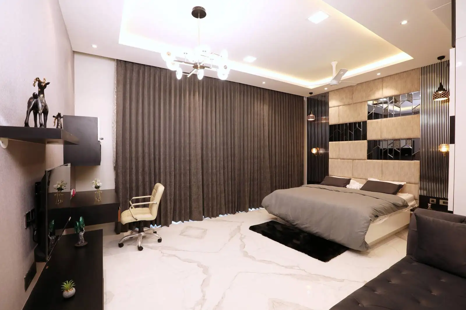 Elegant bedroom with neutral tones, layered lighting, luxurious finishes, and a versatile layout for comfort and productivity.