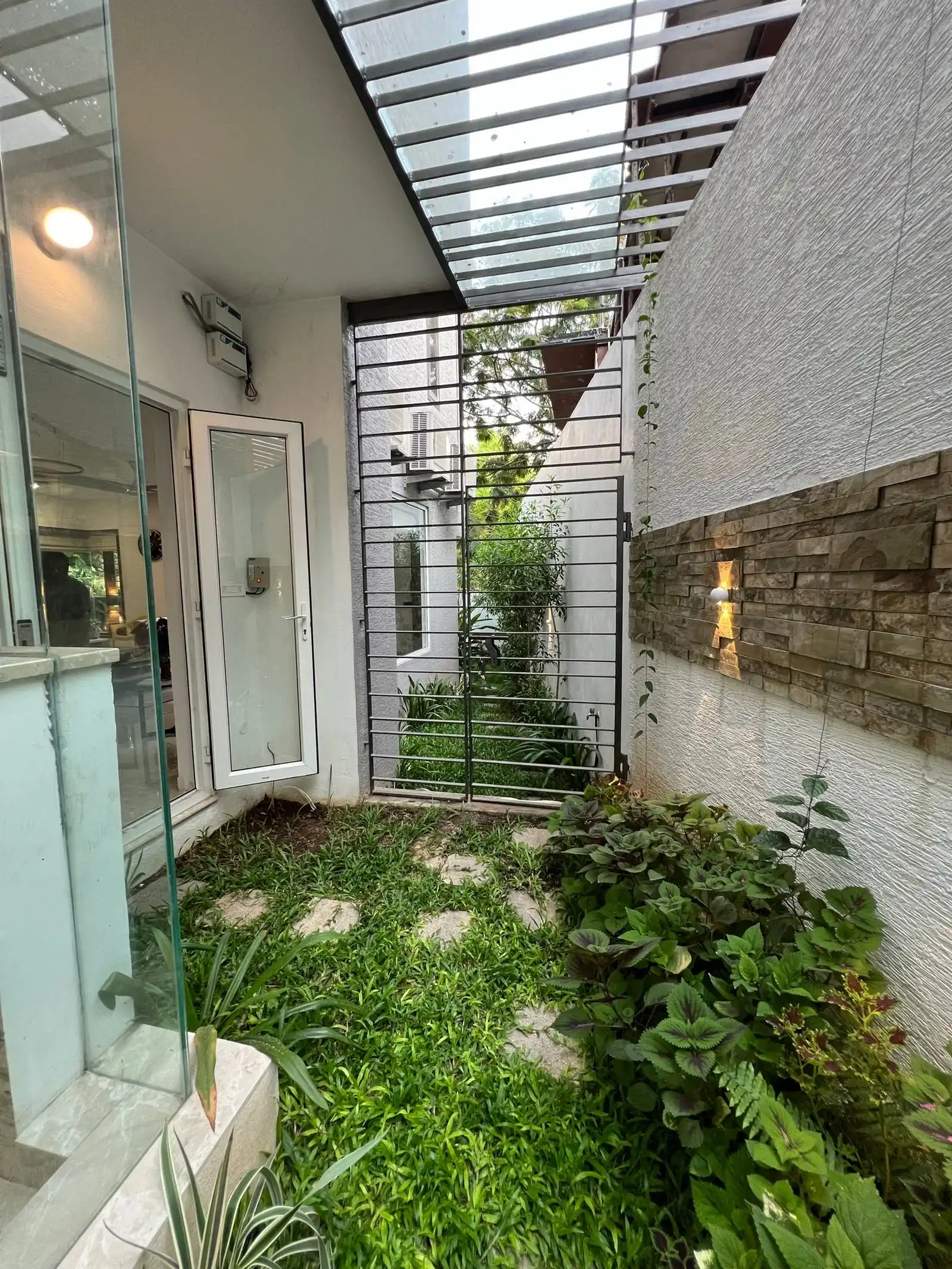 It is directly accessible from the interior through a glass door, visually and physically connecting indoor and outdoor spaces. 