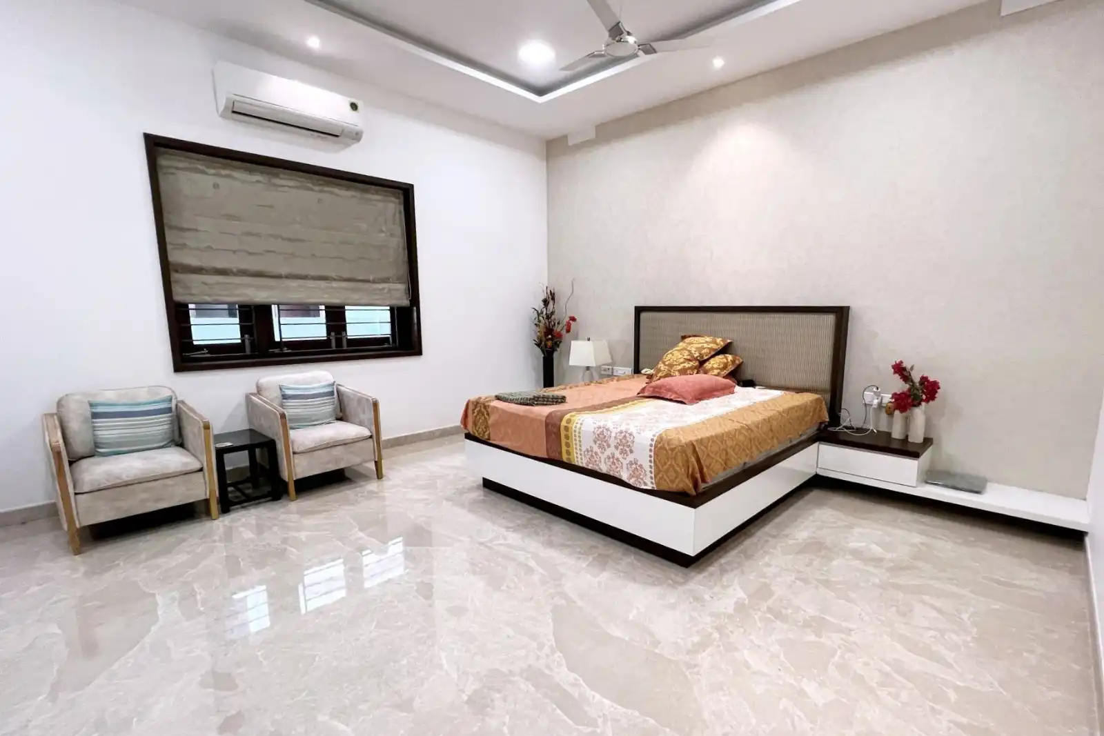 The window is fitted with a Roman blind in a neutral shade, offering privacy and light control.
A split air conditioning unit is installed above the window for climate control.