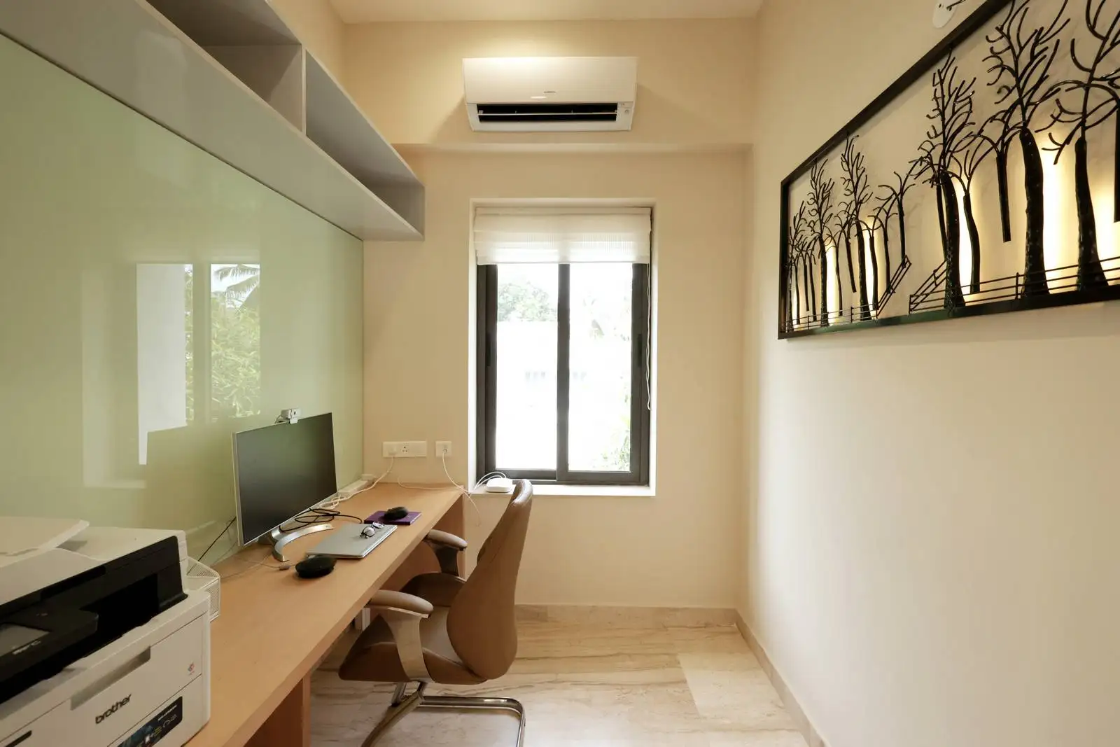 Large windows in the adjacent room ensure the office benefits from abundant daylight, creating a bright and inviting work environment.