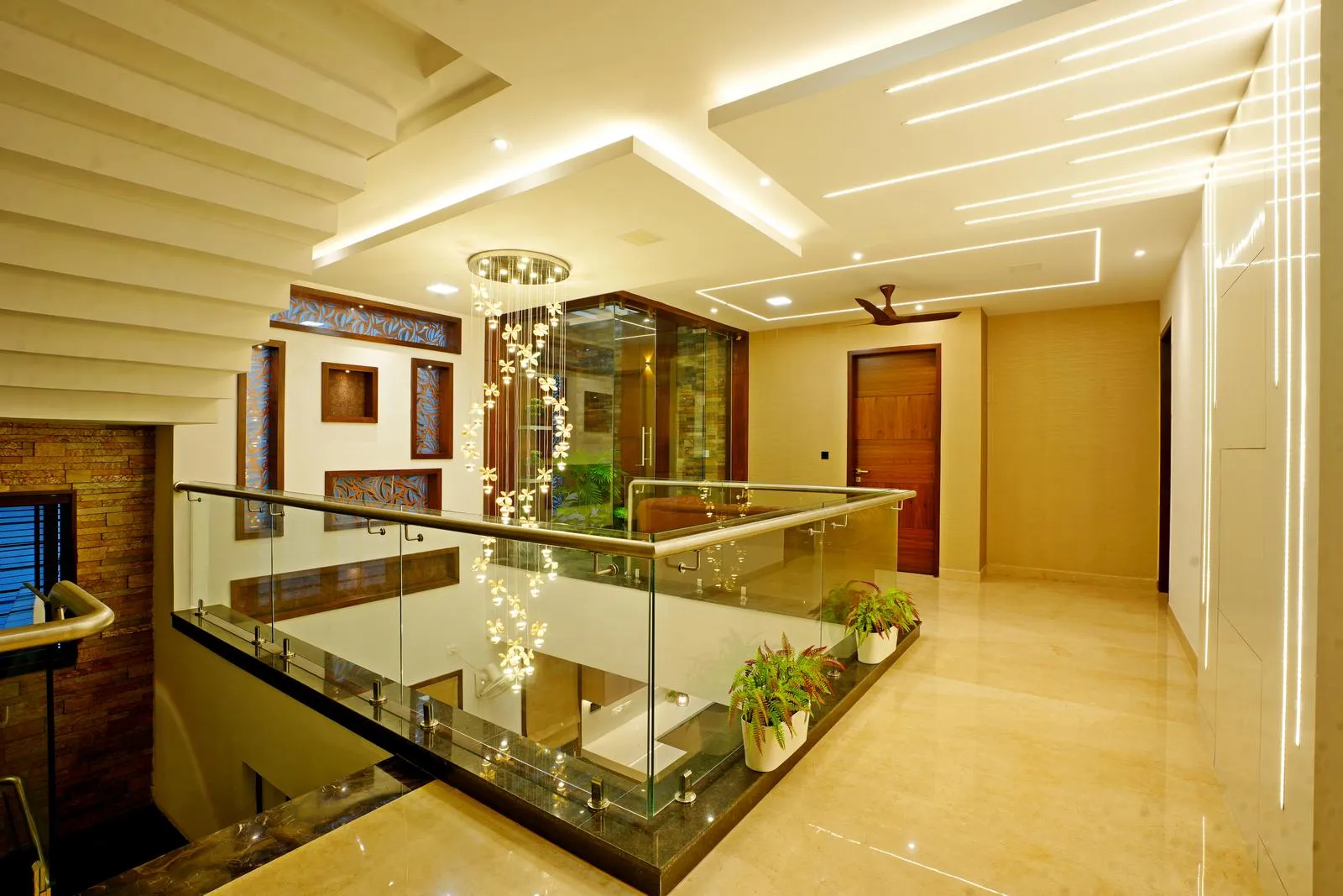 The family area (12'0" × 7'6") acts as a connective hub, linking the staircase and bedrooms around a double-height void with a glass railing and central green atrium.