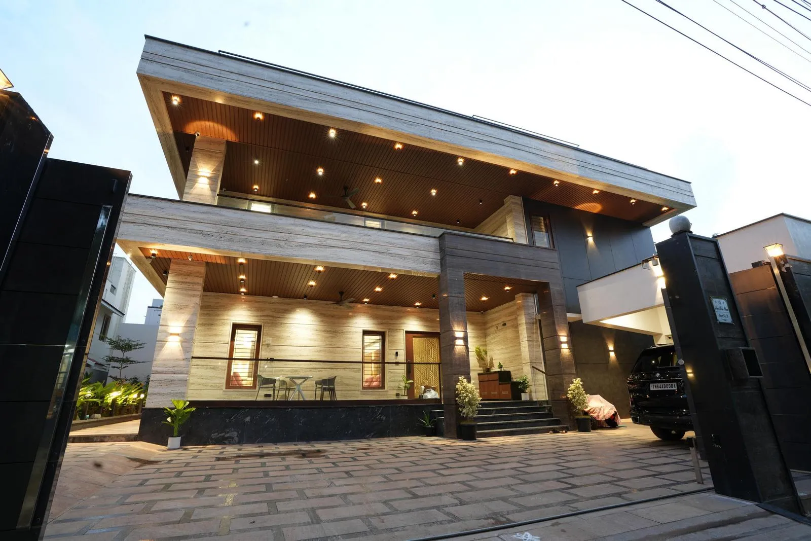 Large glass openings, minimalistic detailing, and strategic lighting enhance openness, elegance, and a timeless, sophisticated ambience.