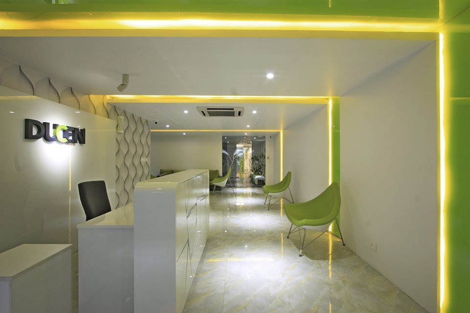 The design features polished flooring, layered wall textures, expansive glass elements, and integrated lighting