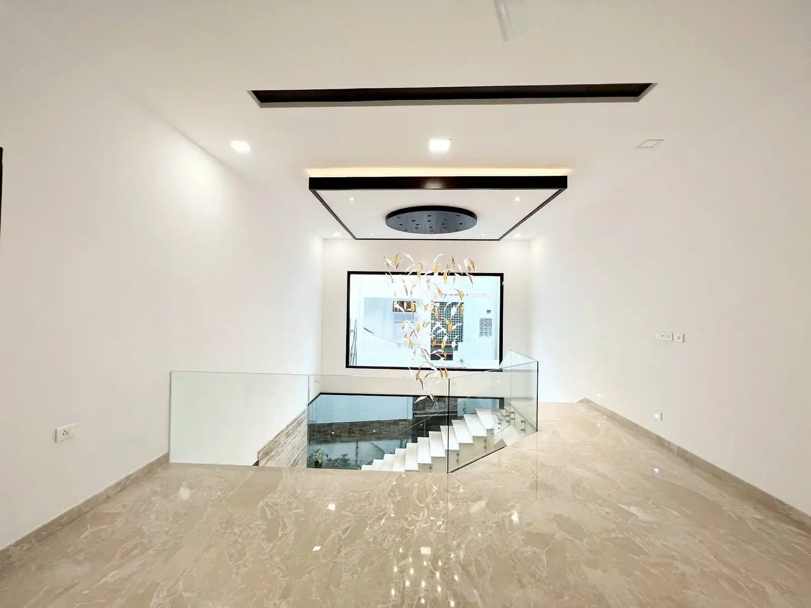 The area is open and spacious, located at the top of the staircase, making it a central gathering spot on the first floor.