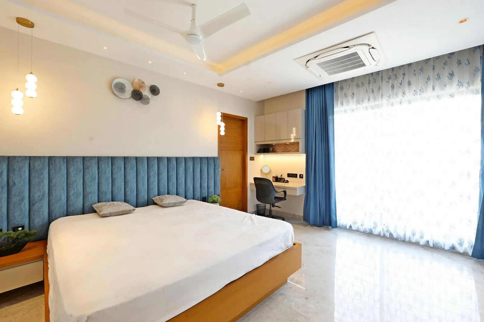 The symmetrical layout ensures balance and smooth circulation. Warm tones, minimalist furniture, and integrated lighting create a modern, functional, and elegant space.