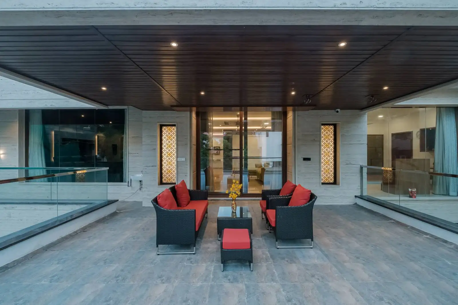 Spacious balcony with stone-textured grey tiles, a stylish, durable outdoor lounge ideal for relaxation and entertaining.