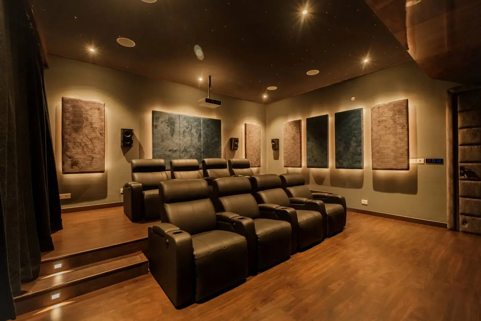 The flooring is finished in rich, dark wood, adding warmth and sophistication while also helping with sound absorption.