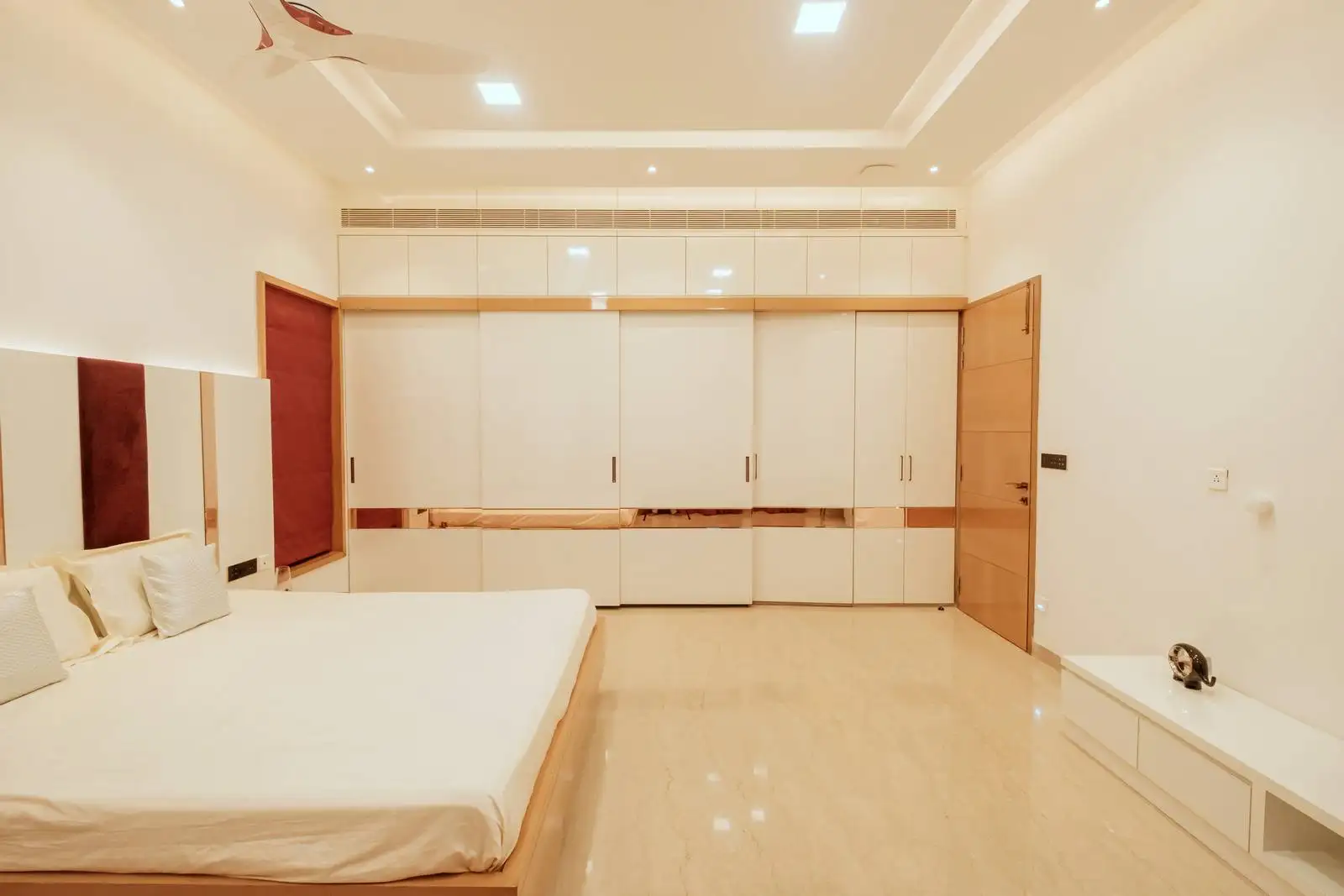 Full-wall wardrobe for maximum storage and a streamlined look. Large window with full-length curtain for drama and privacy.