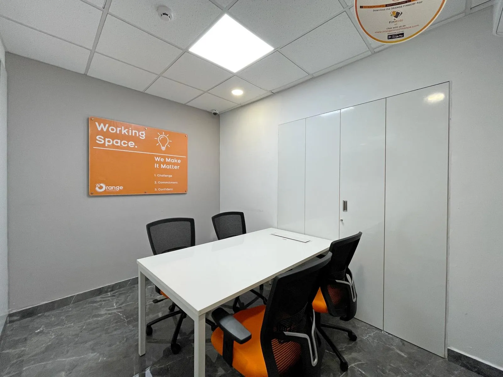 The second-floor meeting room 2  features a sleek, functional layout with ergonomic seating, polished marble floors, and integrated storage. Recessed lighting and subtle branding enhance comfort and professional appeal.