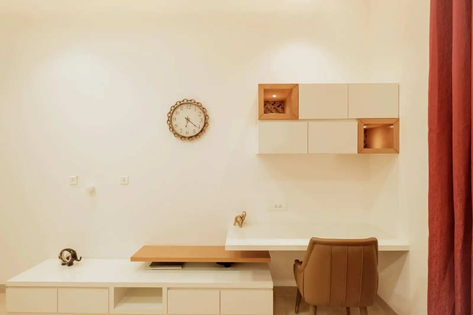 The table is integrated into a larger built-in unit that extends horizontally, providing both workspace and additional storage/display.