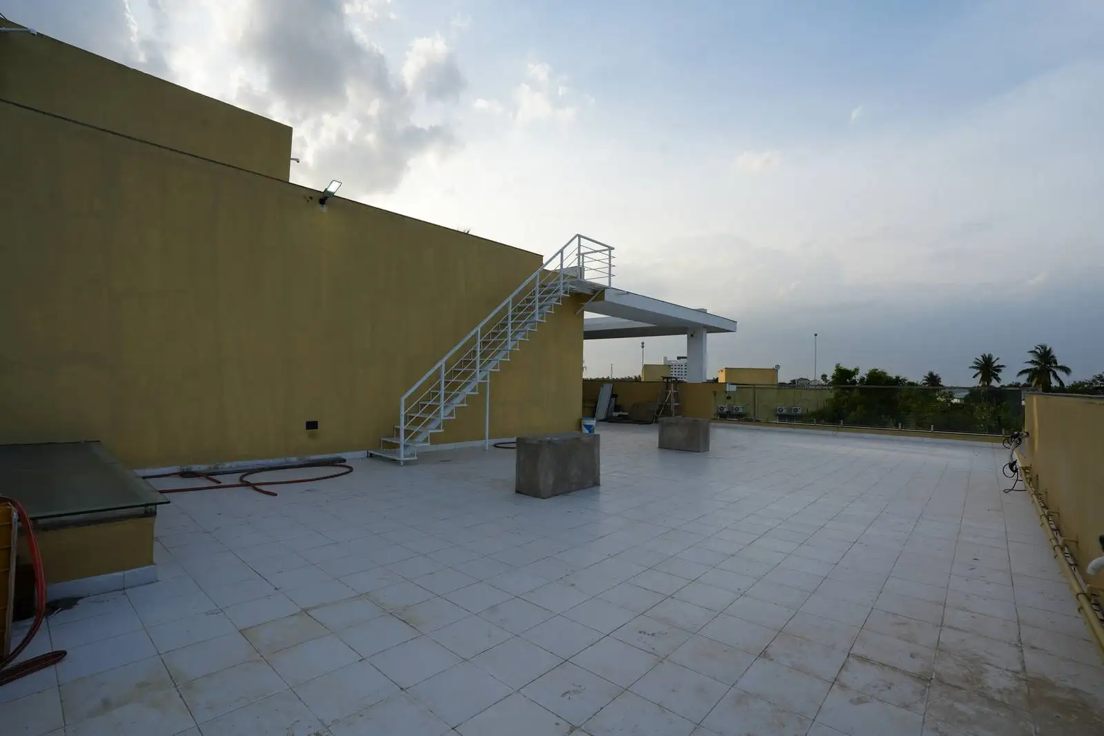 The terrace is enclosed by parapet walls, which enhance safety and privacy while also providing wind protection.