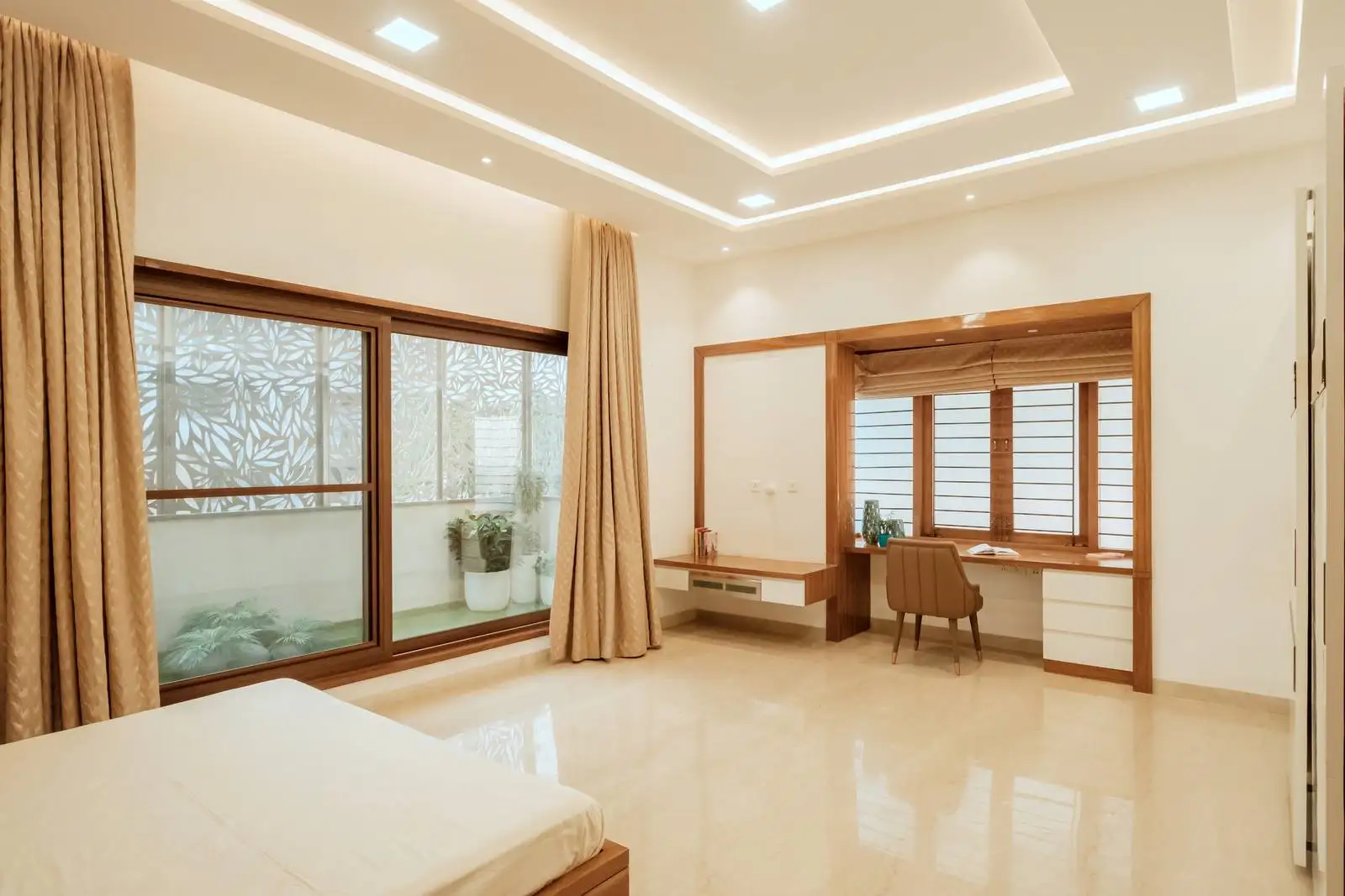 A large sliding glass window/door dominates one wall, providing direct visual and physical access to a private courtyard.