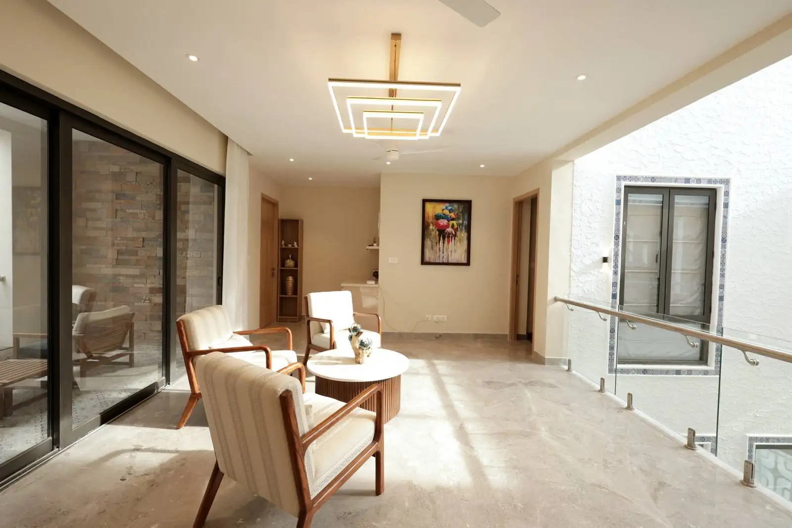 Open layout with visual connections to adjacent rooms and possibly a courtyard double-height space. Furniture placement encourages conversation and maximizes the use of natural light.