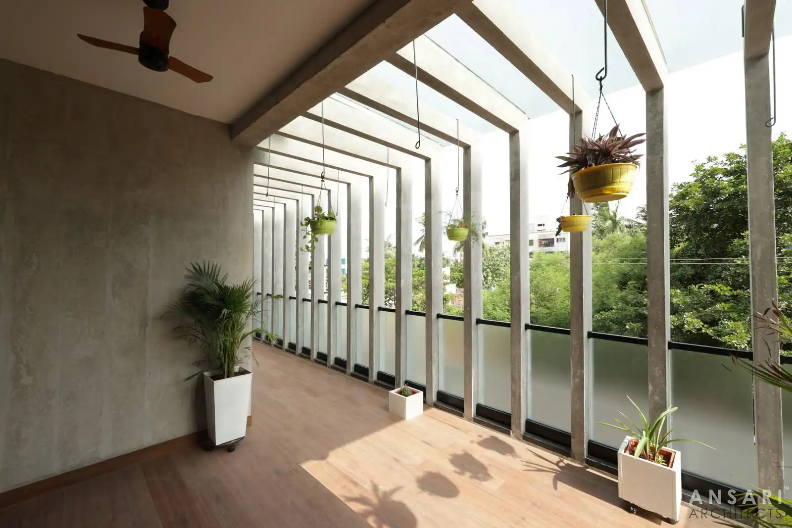 Continuous concrete lines and aligned flooring define a rhythmic, cohesive pathway, enhancing connection to framed outdoor views and surroundings.