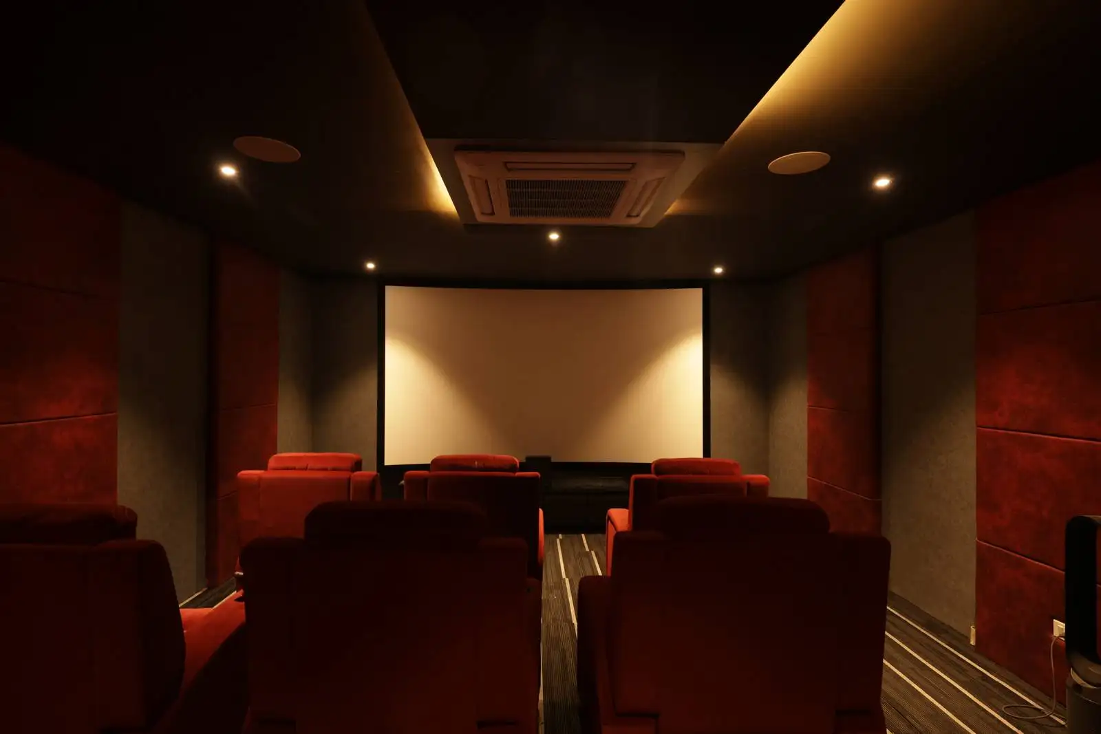 A dedicated home theater with three rows of plush seating, acoustic wall panels, and a dark-toned interior that ensures an immersive, cinema-like viewing experience.
