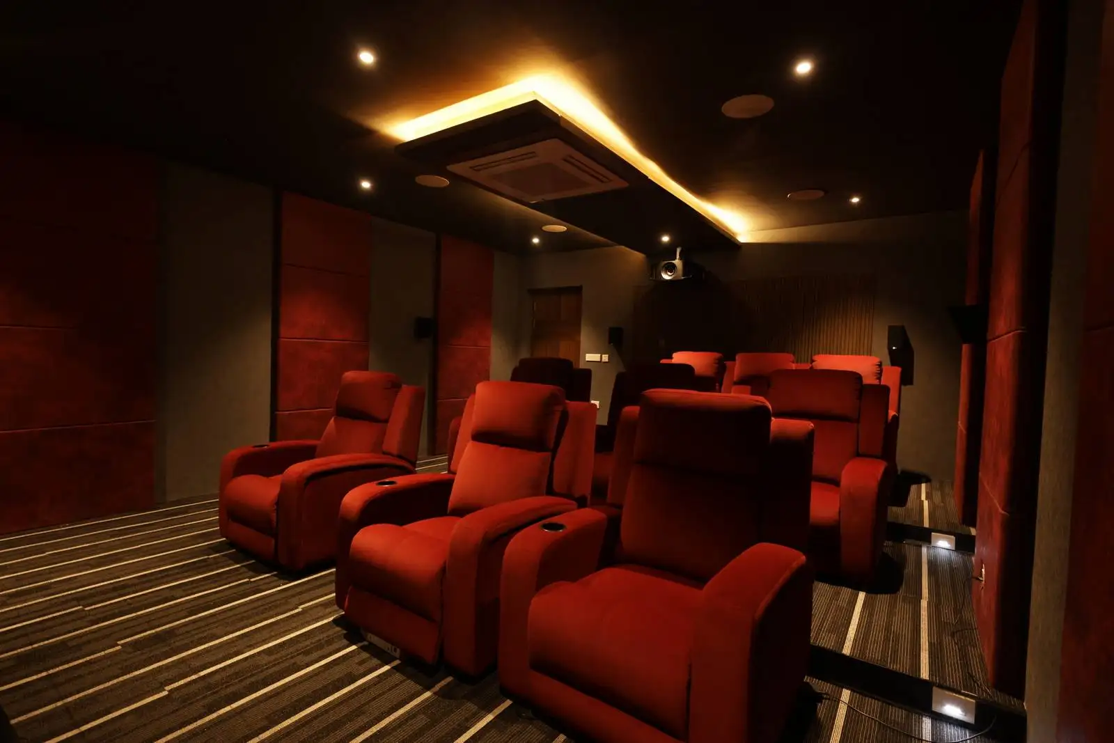 Walls are finished in dark tones, with visible acoustic panels that serve both functional and aesthetic purposes—enhancing sound quality and adding visual texture.