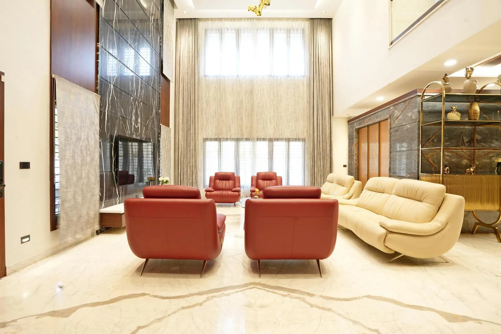 The large windows with sheer drapery allow abundant natural light, softening the space and adding vertical emphasis. A right-side puja room (9'6" x 6'0") complements the space with a serene, sacred ambiance.