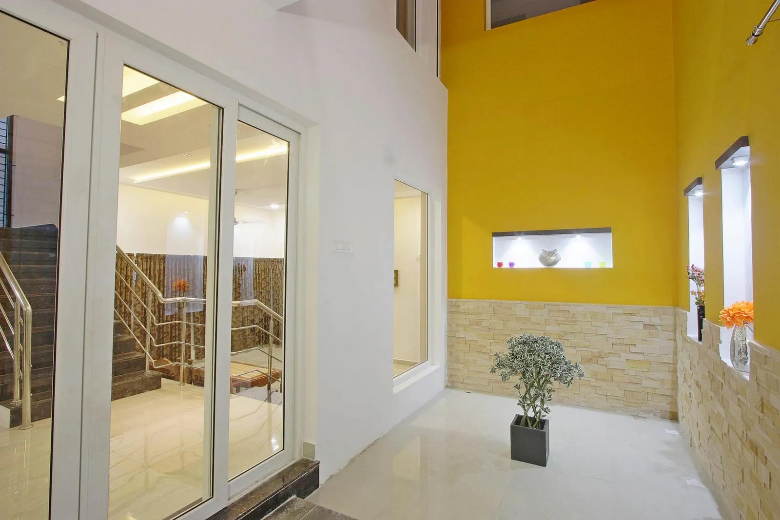 A compact courtyard is introduced at the center of the house, bringing in abundant skylight and a refreshing touch of greenery. This space improves ventilation and creates a strong visual anchor within the home.