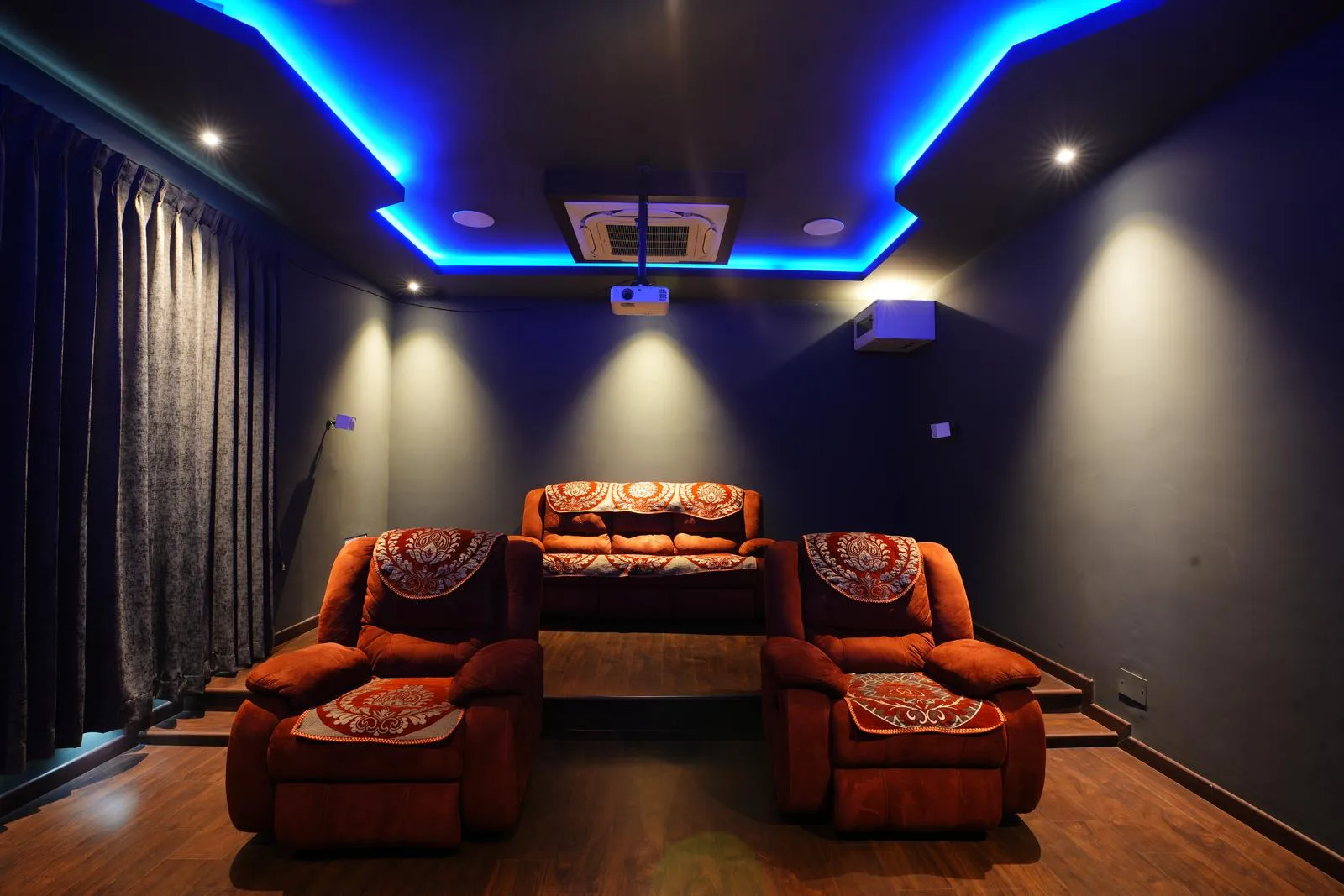 The home theatre (21'0" x 15'0") features an acoustically treated, enclosed space with tiered seating, ceiling-mounted projector, and wall speakers for optimal sound and viewing. Dark finishes enhance screen contrast and focus, creating a premium cinematic experience.