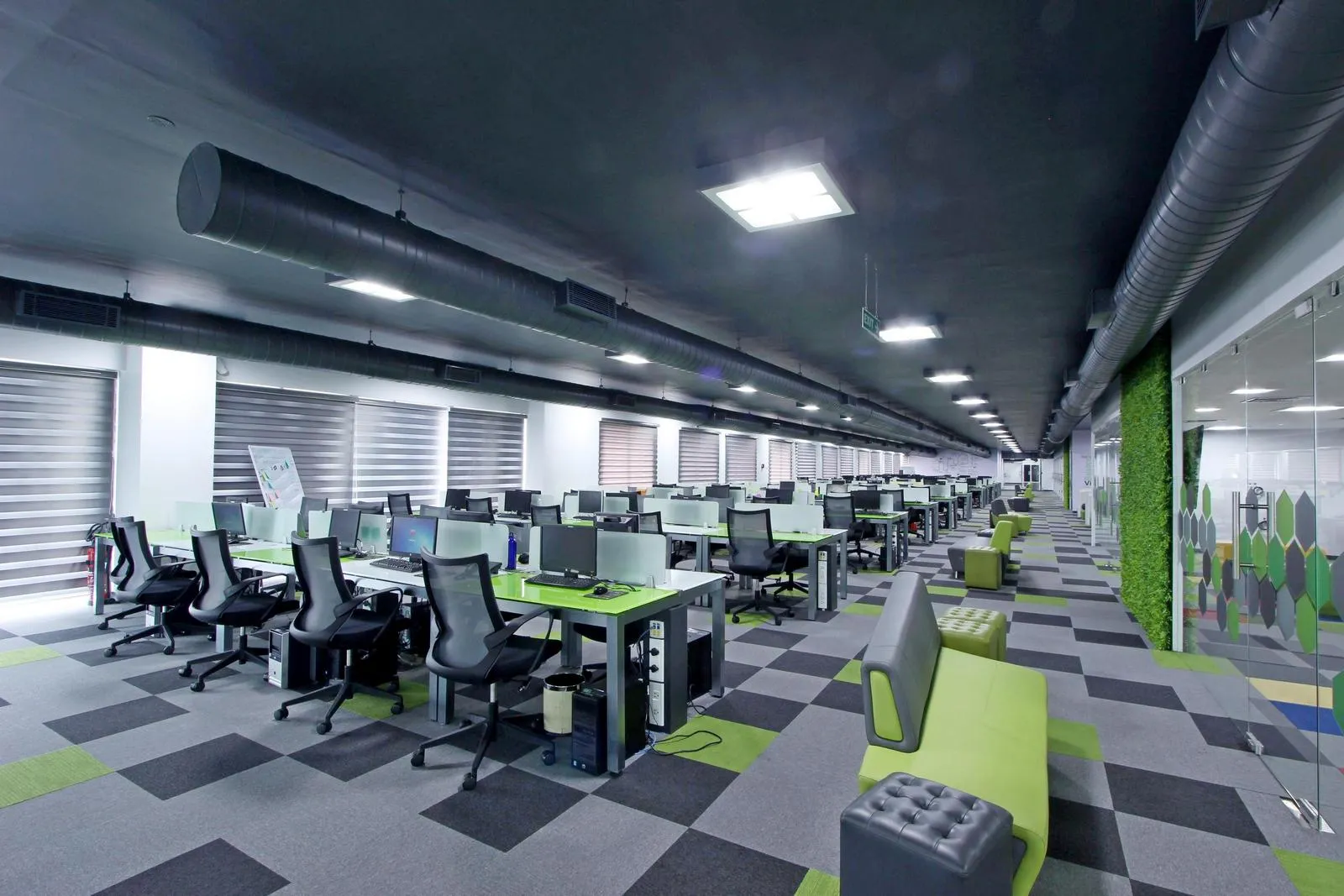 4th-floor workstations combine white and lime modular desks, ergonomic chairs, and vertical green walls, creating a modern, open, and functional workspace. Frosted glass partitions, carpet flooring, and recessed LED lighting enhance flow and visual appeal.