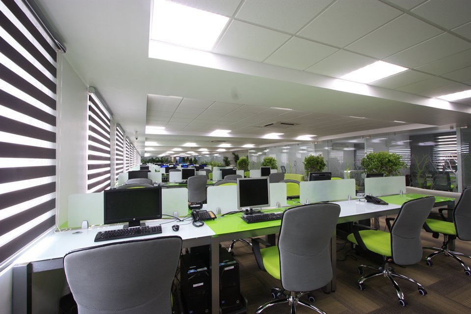 Designed open-plan office with structured desks and partitions, balancing collaboration and privacy for optimal workflow.