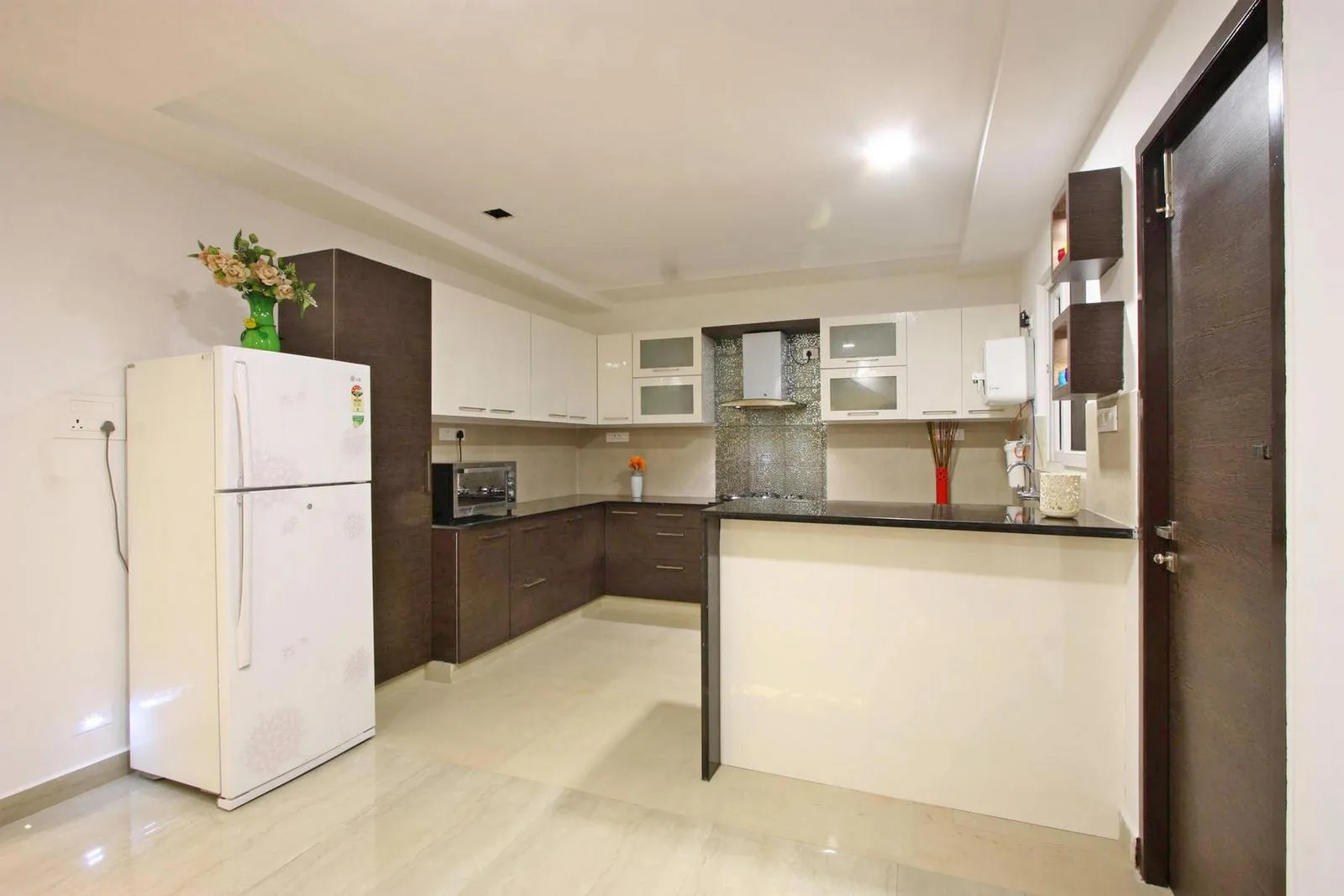 The open kitchen is designed to enhance spatial continuity. An open-plan layout allows the house to feel expansive and connected, immediately noticeable upon entry.