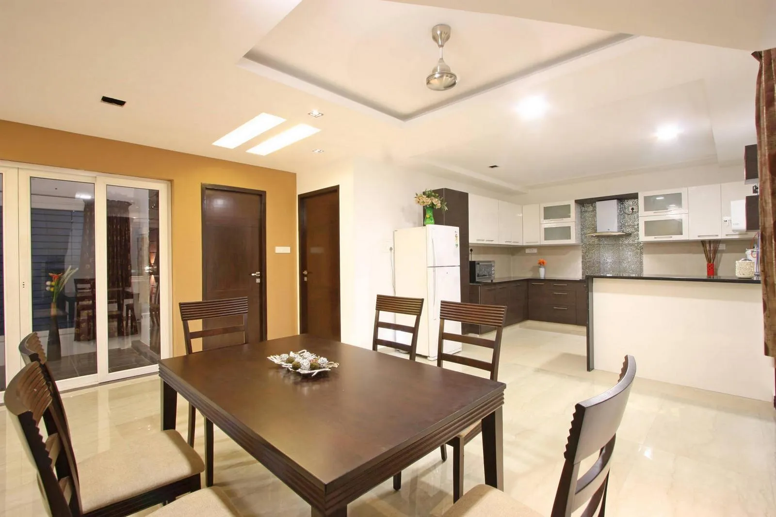 The open-plan layout seamlessly links the dining, kitchen, a with the central dining zone acting as a transitional core.