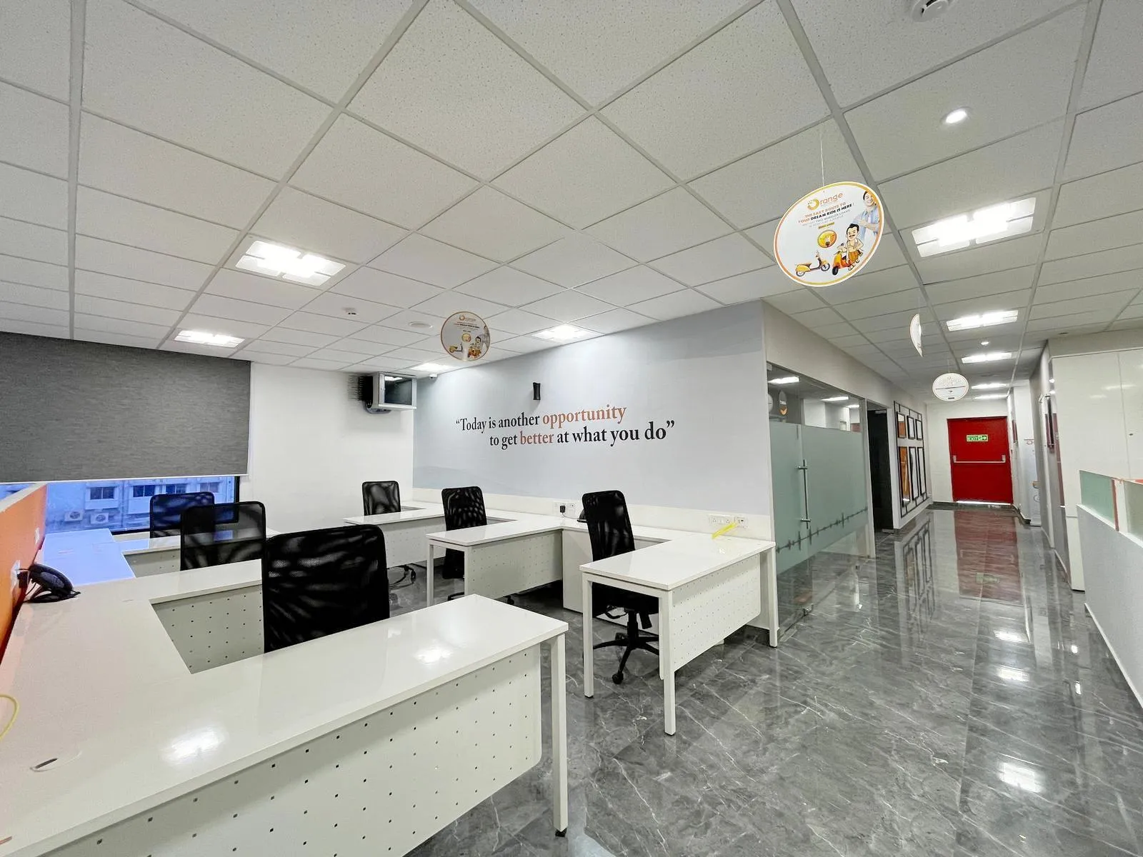 Grey marble flooring, frosted glass partitions, and integrated lighting enhance openness, comfort, and a modern corporate aesthetic.