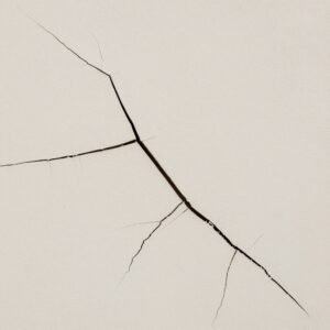 How to Stop Cracks in Your Home: Professional Guidance from Architect Dameem Ansari 3 Close-up of a beige wall with a large, branching crack running diagonally across it