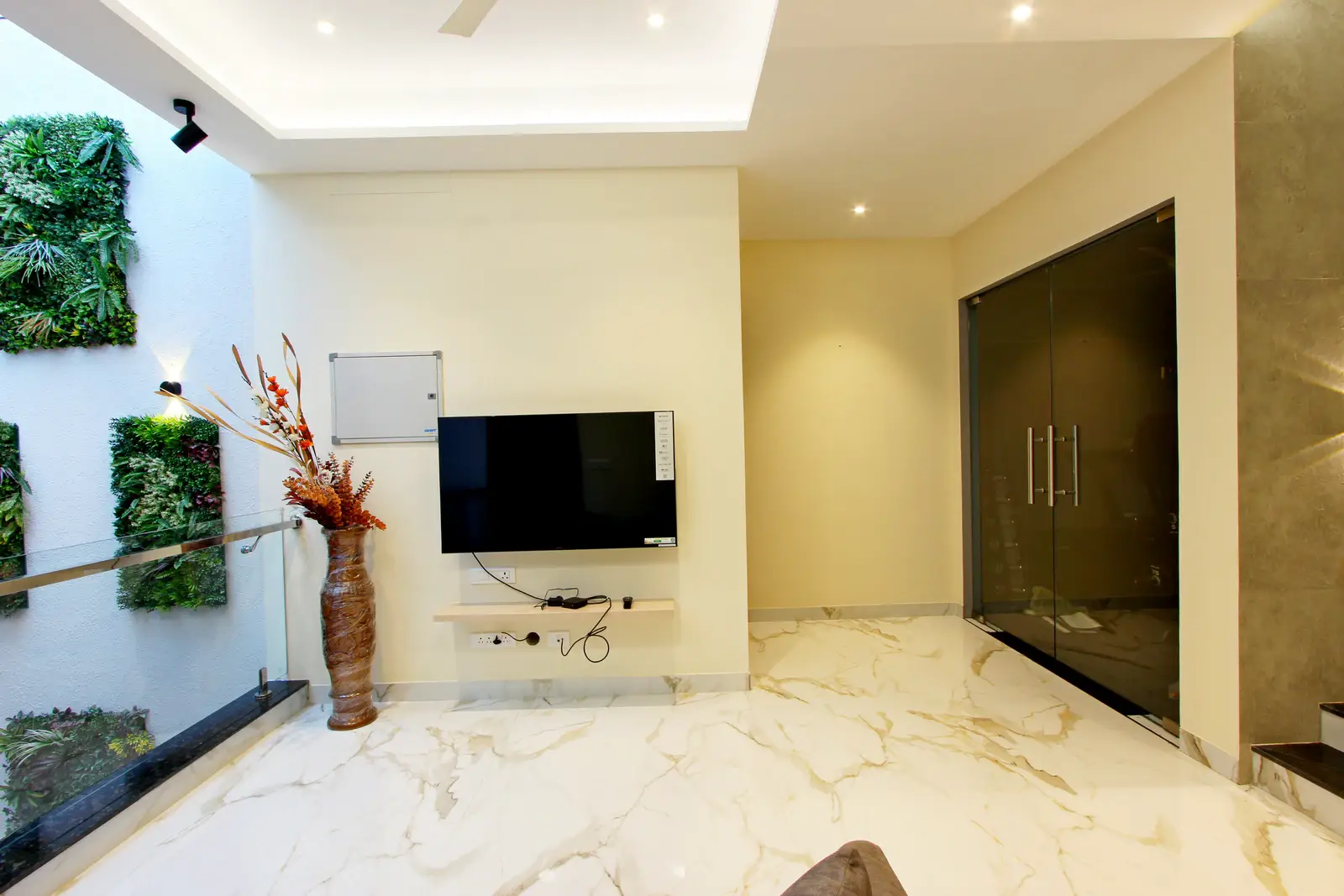 First Floor - Elegant design in the living area features glossy white marble flooring with subtle grey veining, creating a serene, luxurious, and artistic ambiance throughout the space.