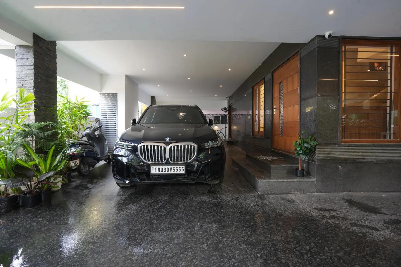 Ground floor - The stilt floor and landscaping create openness, featuring a dog kennel, generator provision, and slate stone pillars seamlessly integrated with the natural surroundings.


