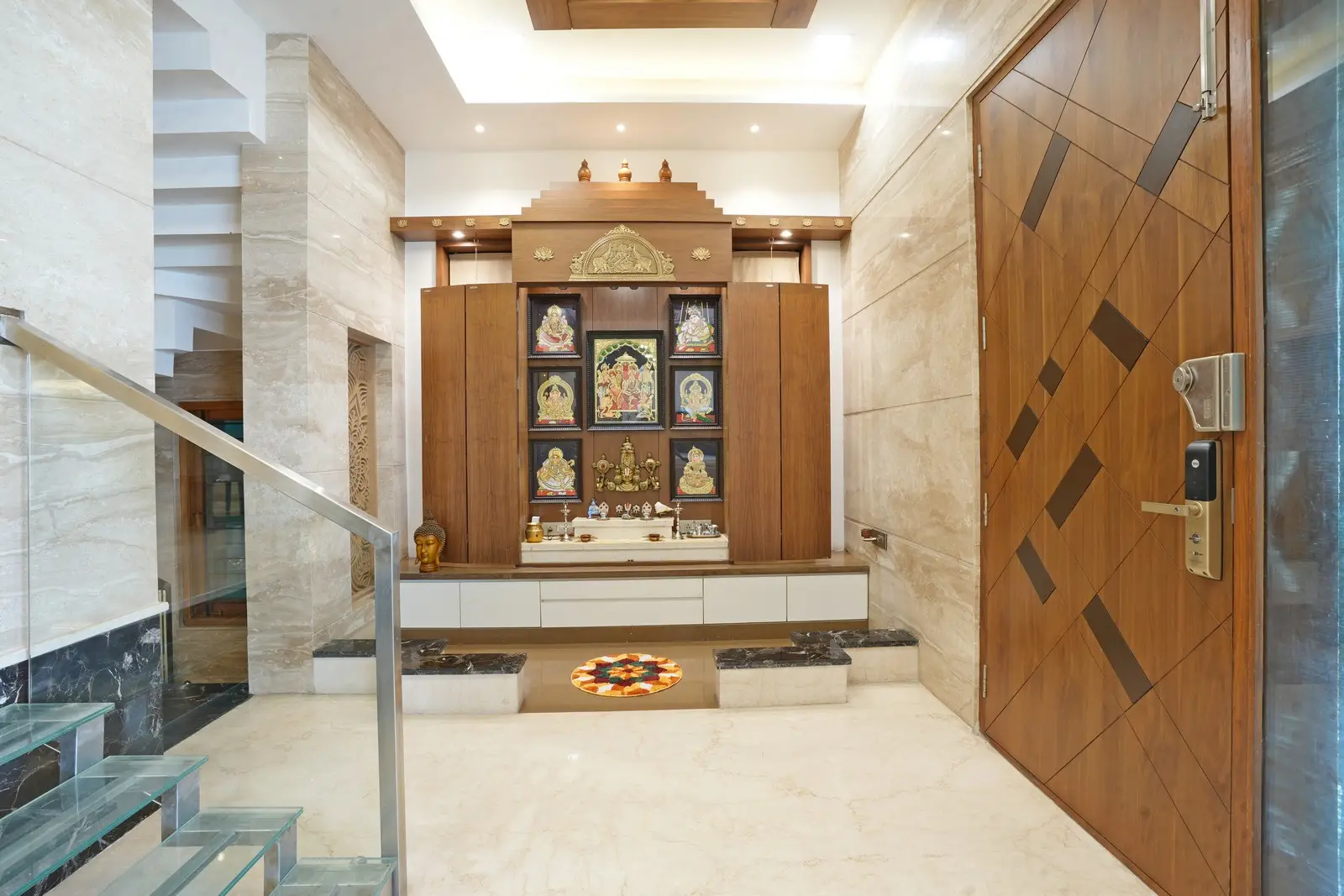 First Floor - the pooja area features dark flooring, a partition, Diana marble with horizontal grain, and glass windows, combining elegance, divinity, natural light, and easy maintenance.