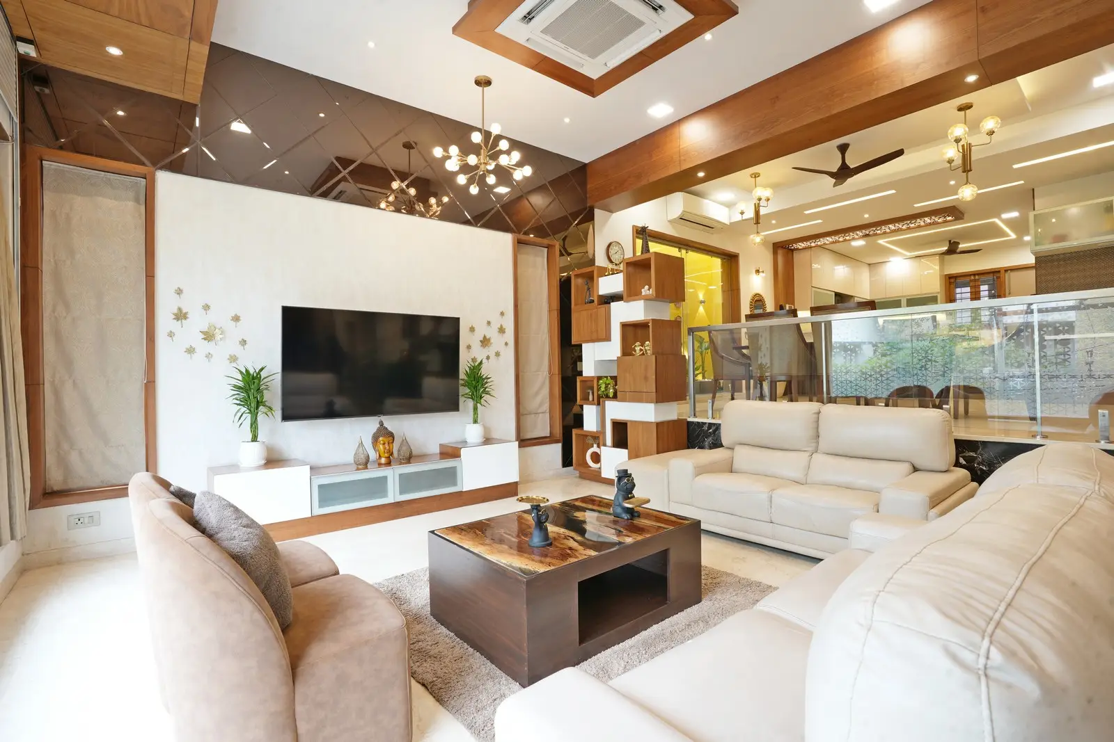 The TV unit with patterned wallpaper, decorative accent wall, copper beveled glass, rolling shutter, and partitions blends luxury, practicality, and distinct spatial character with the foyer’s level difference.
