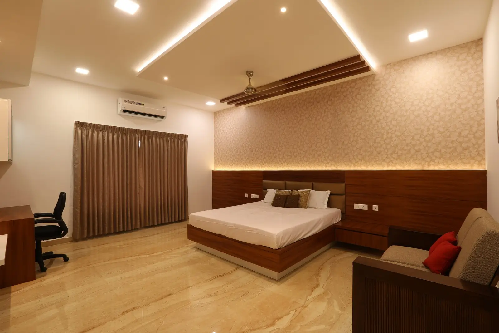 This master bedroom features elegant floating elements, warm 4000K diffused lighting, and a beautifully finished frosted walk-in wardrobe.