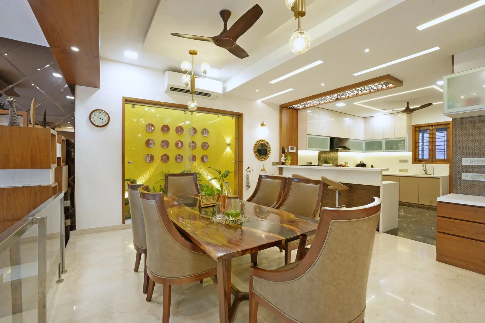 The dining and living areas feature Italian marble, veneer finishes, live wood furniture, a small courtyard, quartz breakfast counter, glass partition, and centralized air conditioning for luxury and practicality.