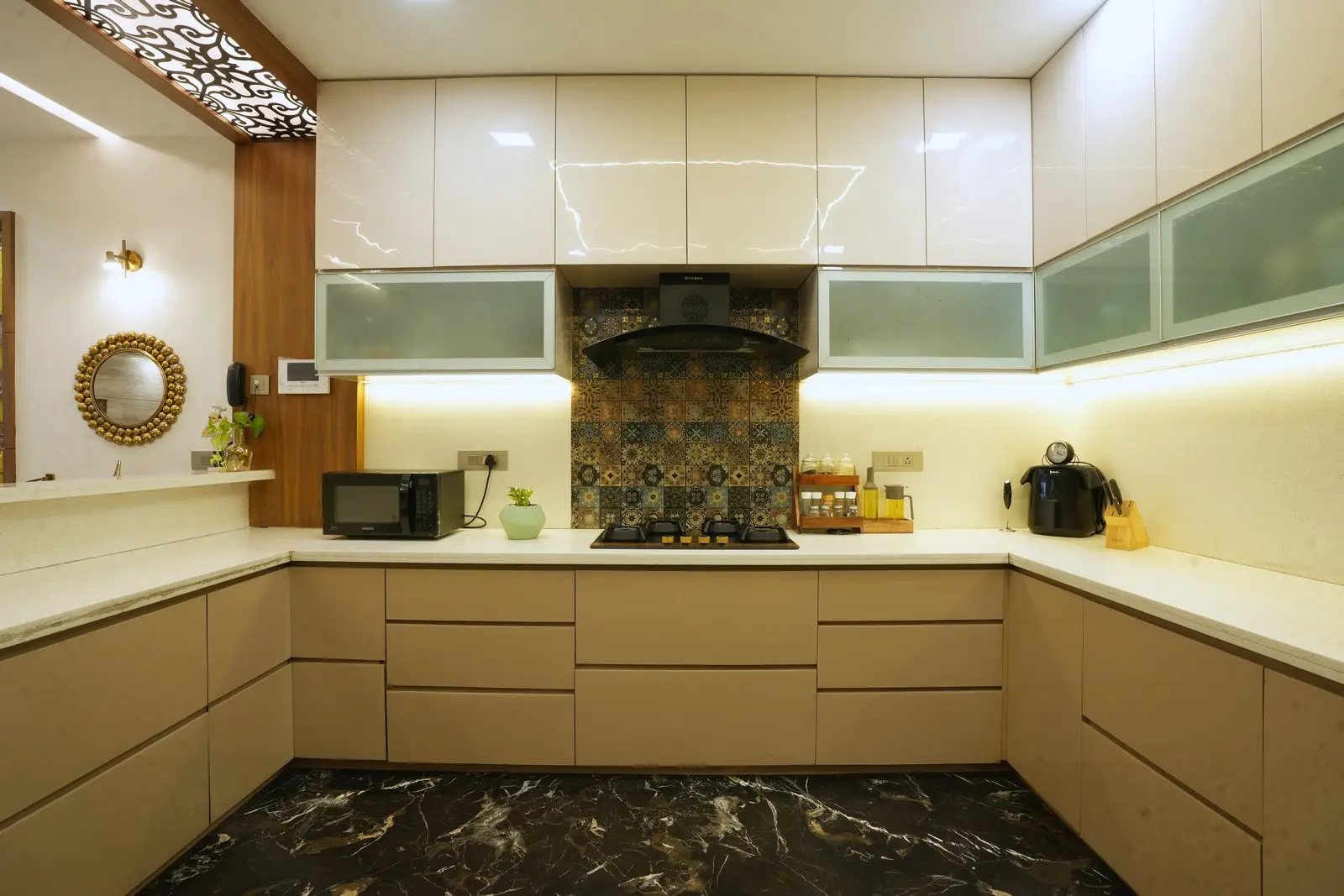 Equipped with a Faber chimney and stove, stainless steel sink with extendable tap, RO provision, and Bosch OTG oven, combining style and effortless functionality.

