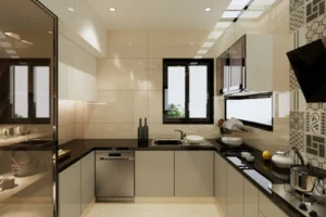 Sleek modern kitchen with shiny black countertops, beige cabinets, a stainless steel dishwasher, a sink below a window, plates and bowls on a drying rack, patterned tile backsplash on the right wall, and various kitchen items including a lemon and a teapot on the counter.