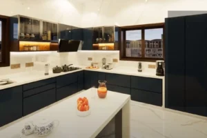 Modern kitchen with black lower cabinets and upper cabinets with glass doors, white marble countertops, and a white island in the center holding a bowl of apples, a pitcher of juice, and a clear glass. Appliances include a stove with pots, a blender, a coffee maker, and a toaster. A window reveals buildings outside, and the floor is white marble.