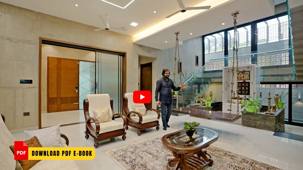 Modern living room with two wooden armchairs with cushions, a glass-top coffee table on a patterned rug, a wooden swing with ropes hanging from the ceiling, and large windows with glass panels, featuring a man standing near the swing.